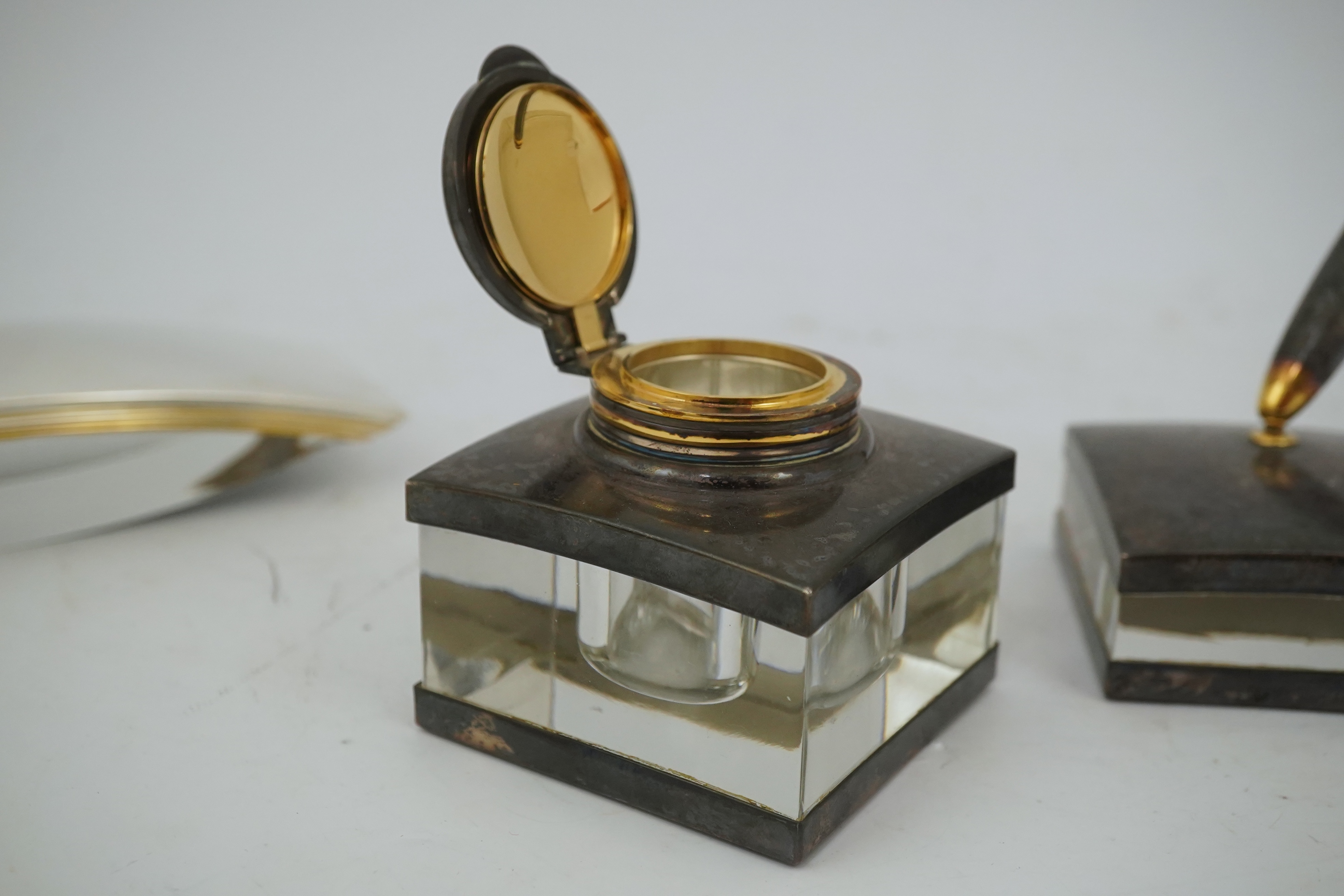 A Montblanc three piece German silver and glass desk set comprising pen stand, inkwell and blotter, each glass mounted, silver engraved with the Montblanc logo